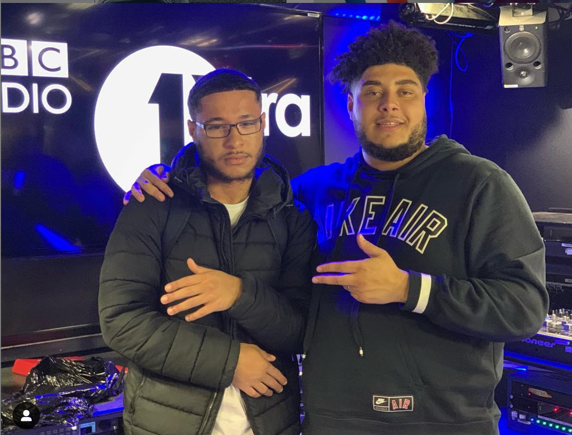 Squintz and another person posing in the BBC Radio 1Xtra studio